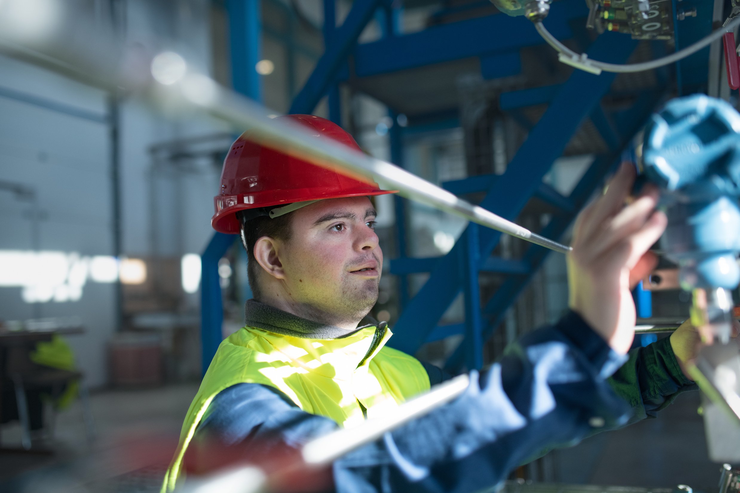 Young Man with down Syndrome Working in Industrial Factory, Social Integration Concept.